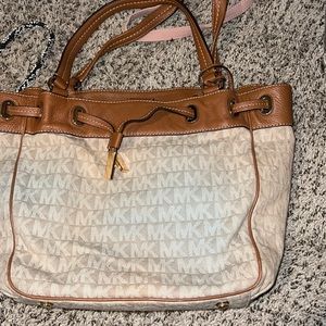 A brown and tan micheal kors purse